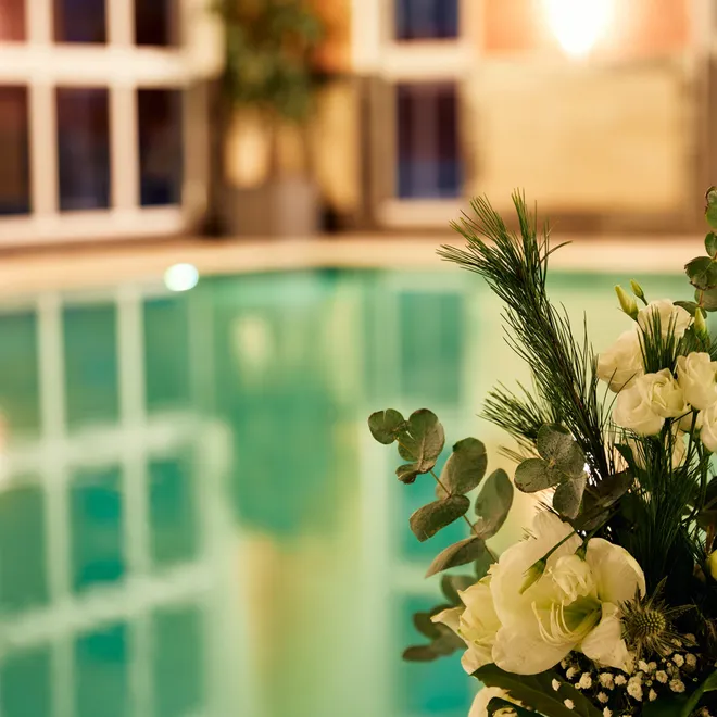 Elegant floral arrangement near indoor spa pool with relaxing ambiance