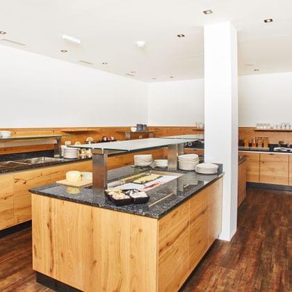 Modern breakfast buffet with wooden counters and assorted food items