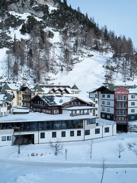 Hotel complex surrounded by snowy alpine mountains in Austria