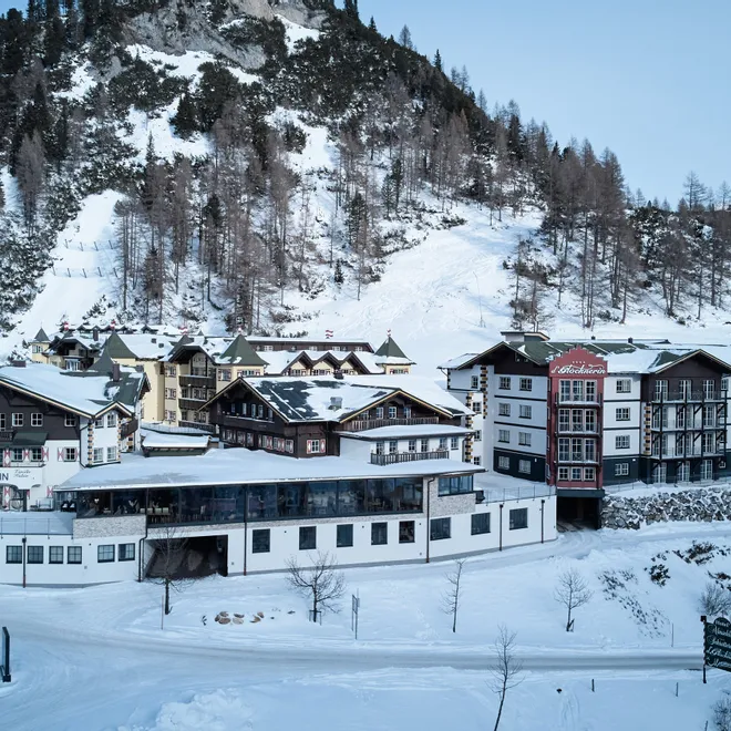 Hotel complex surrounded by snowy alpine mountains in Austria