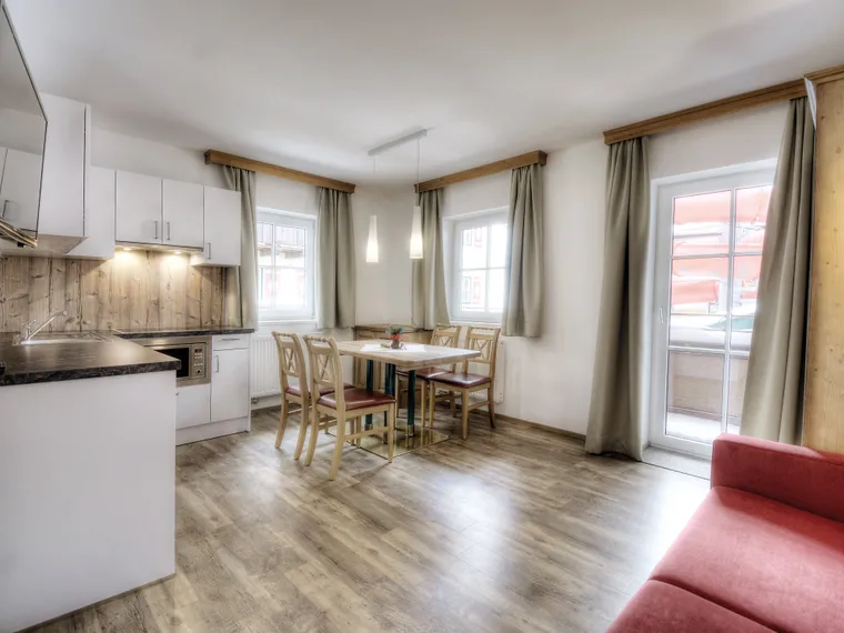 Modern holiday apartment with open kitchen, dining area and balcony access