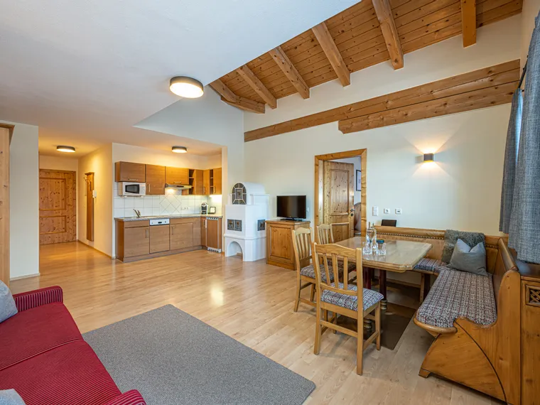 Cozy alpine-style holiday apartment with wooden kitchen, dining area and beamed ceiling