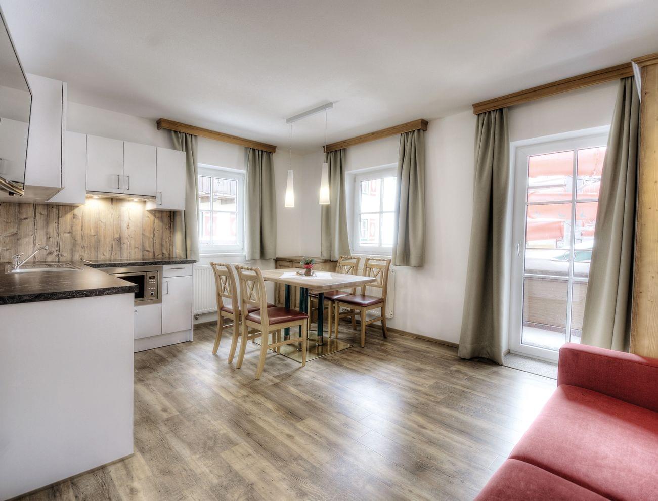 Modern holiday apartment with open kitchen, dining area and balcony access