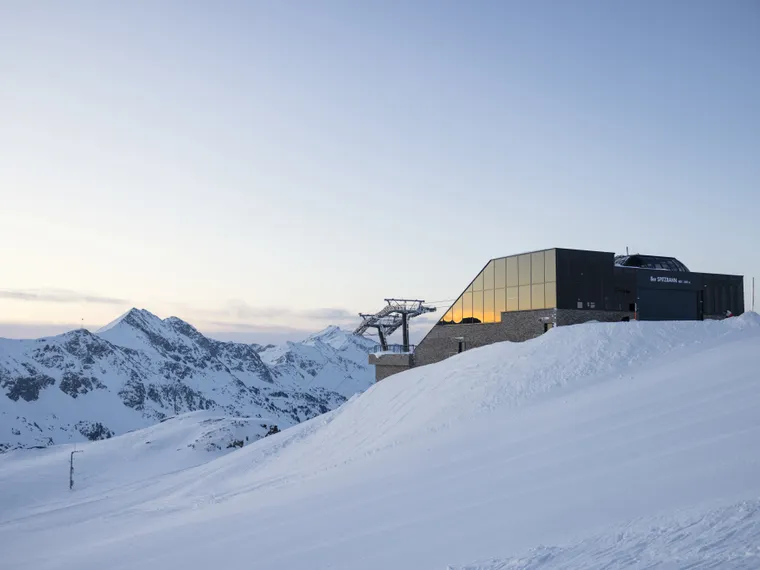 Ski station on snow-covered mountain at sunrise in the Alps