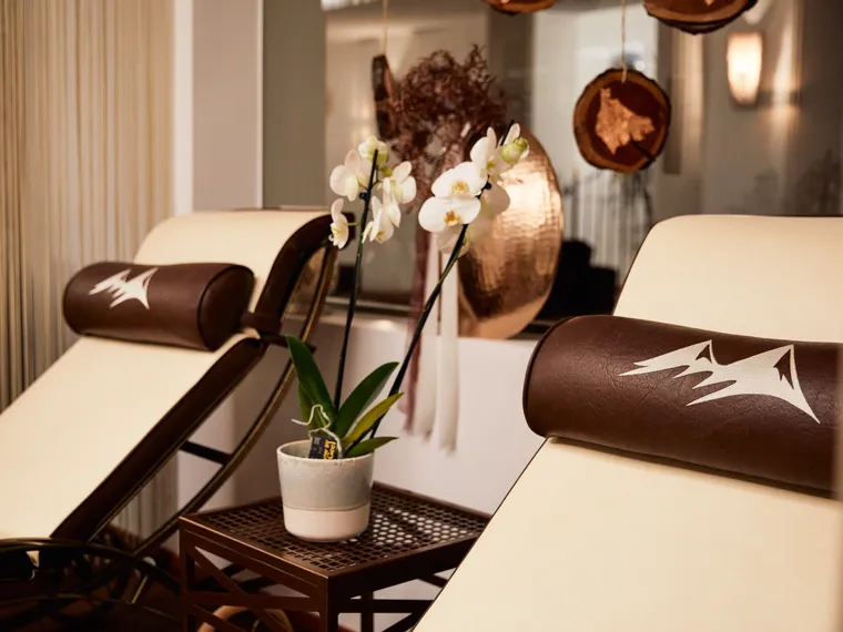 Spa relaxation chairs with orchid plant and soft ambient lighting